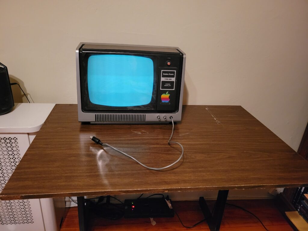 TRS-80 Model I monitor sitting on a wood desk